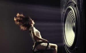 woman in front of large speaker