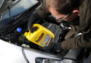 Man pouring coolant inside car coolant reservoir