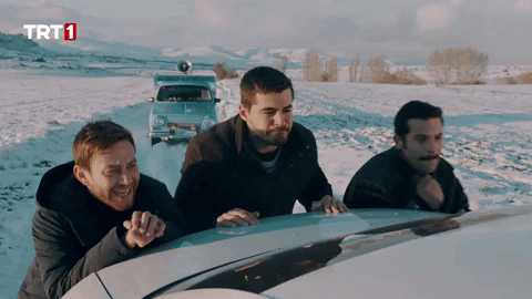 Men pushing dead car