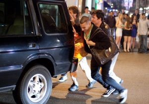 People pushing an SUV